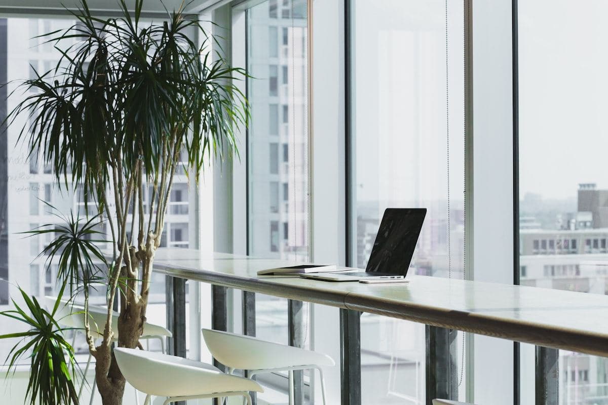 Bright office with a laptop by floor-to-ceiling windows